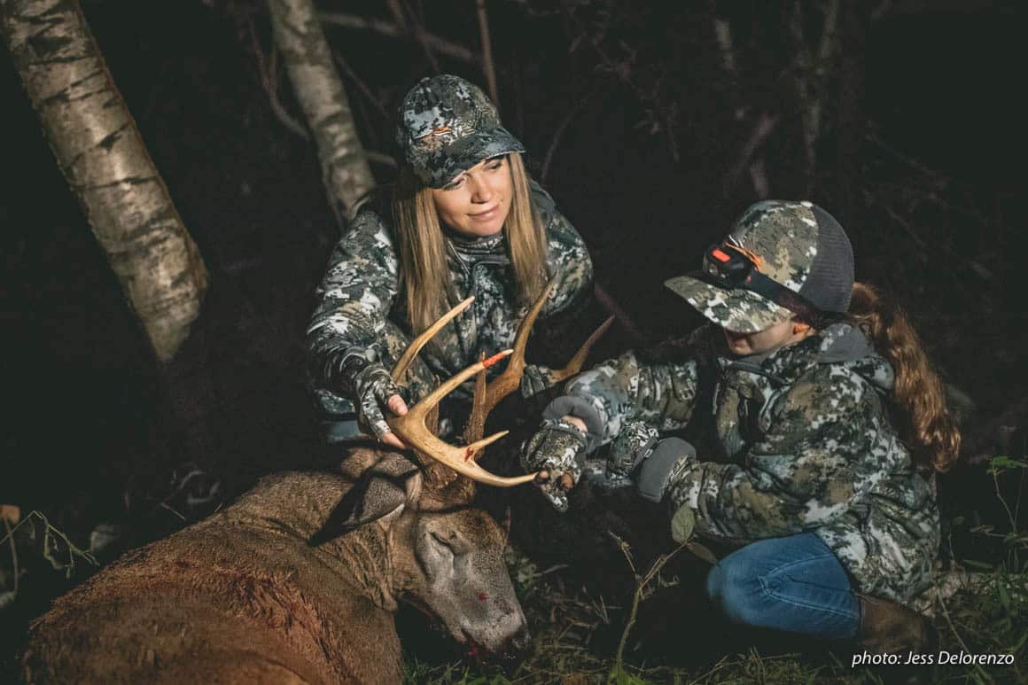 Mother and daughter hunting with whitetail buck in the Northeast.