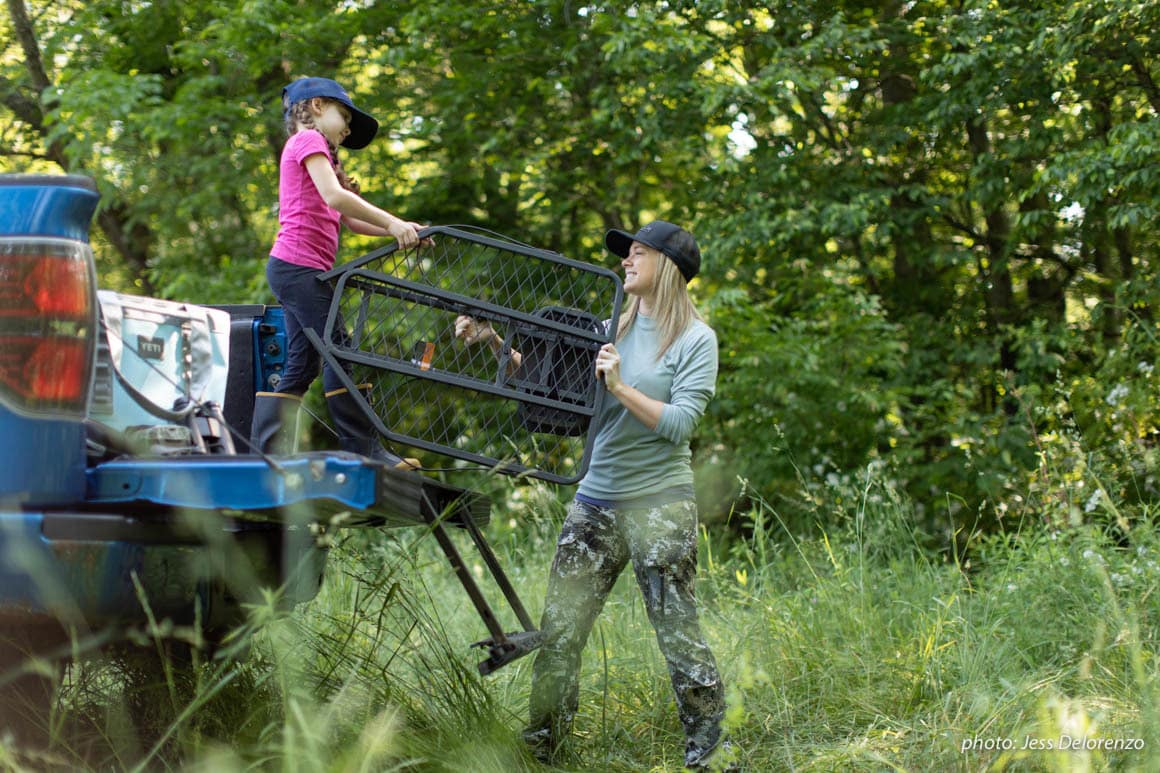 Mother and daughter setting up a treestand in Pennsylvania for hunting.