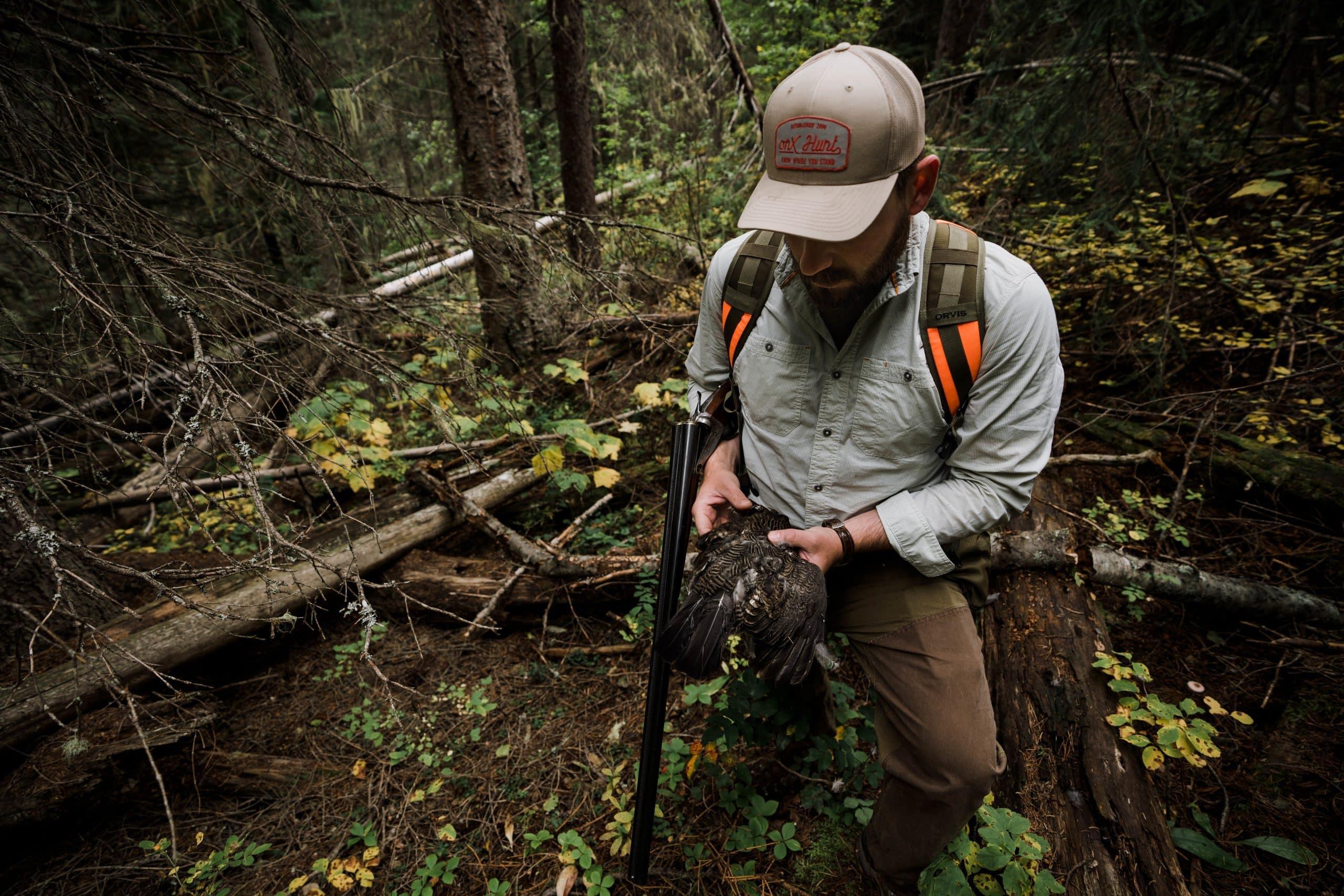 A hunter holds a spruce grouse harvested in northwest Montana.
