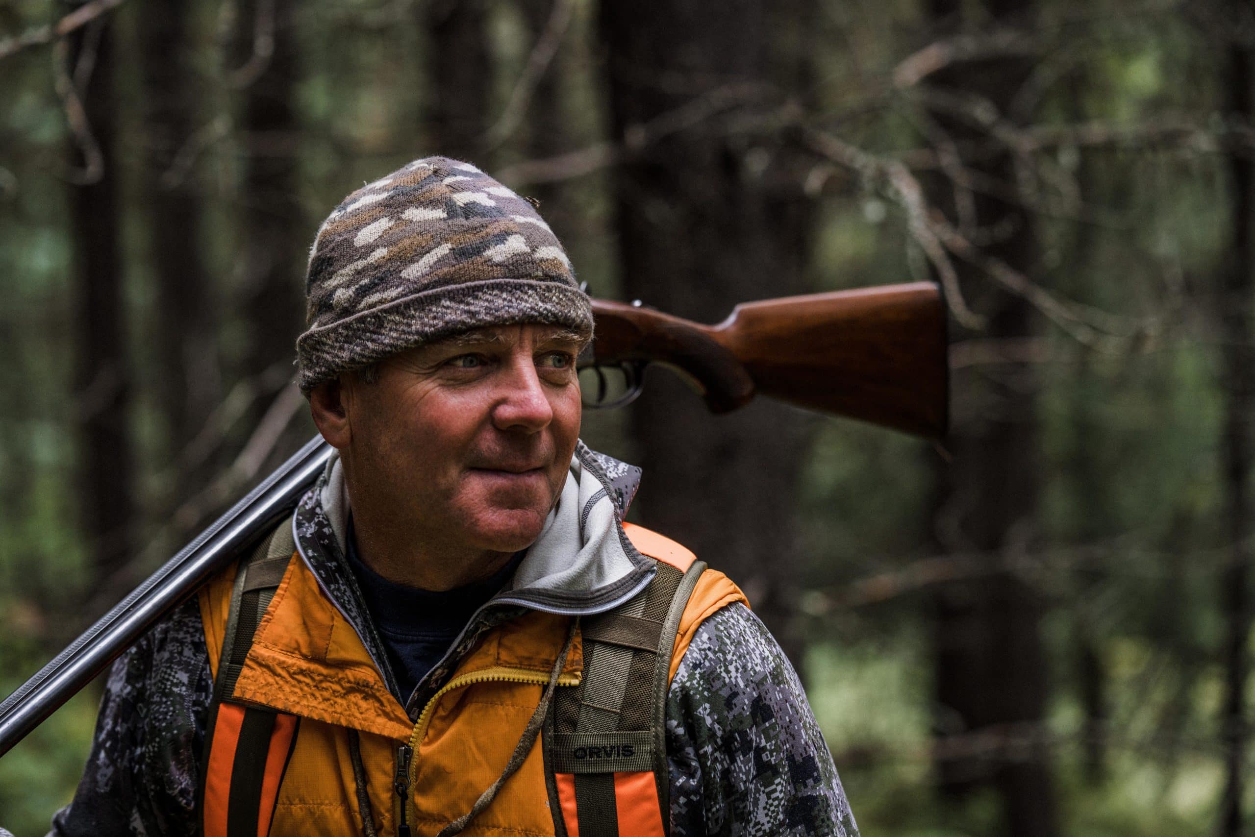 Montana outfitter Tim Linehan carries a shotgun while grouse hunting.