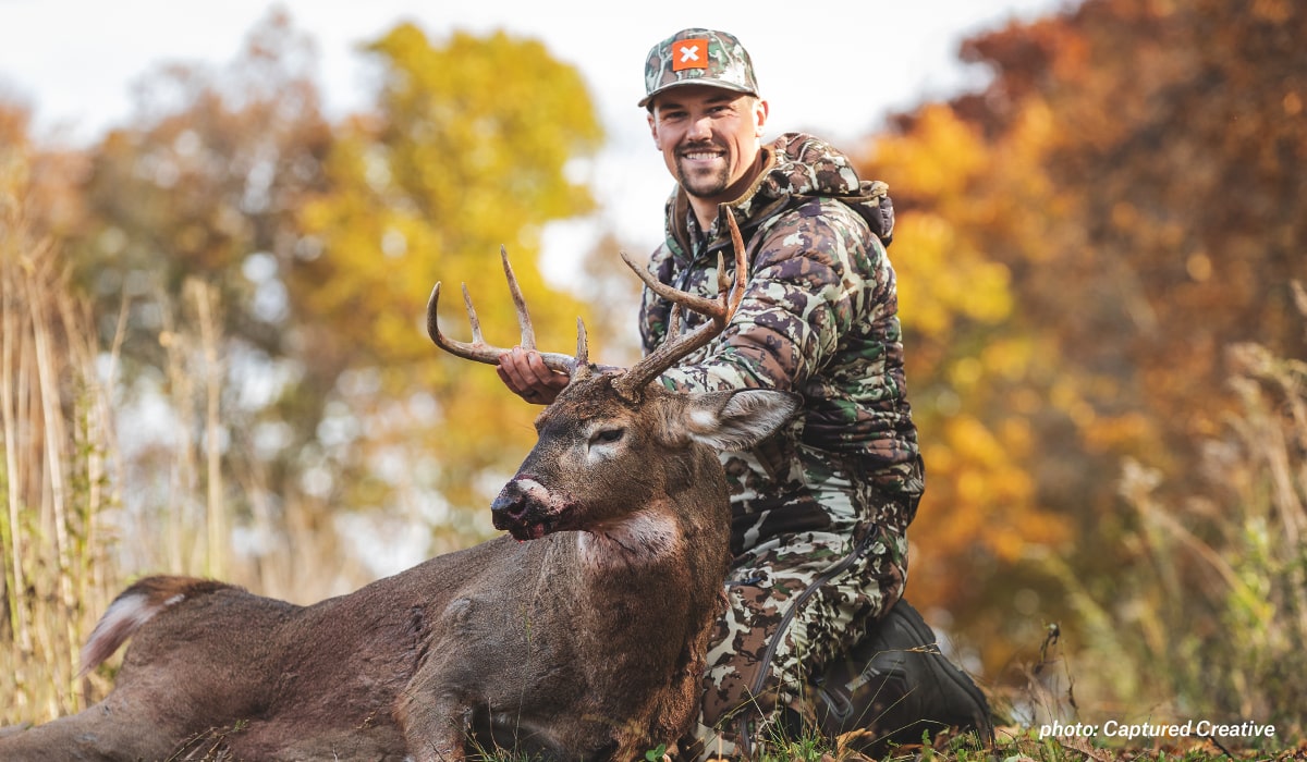 Mark Kenyon poses with a whitetail buck shot on MeatEater's Back 40 property.