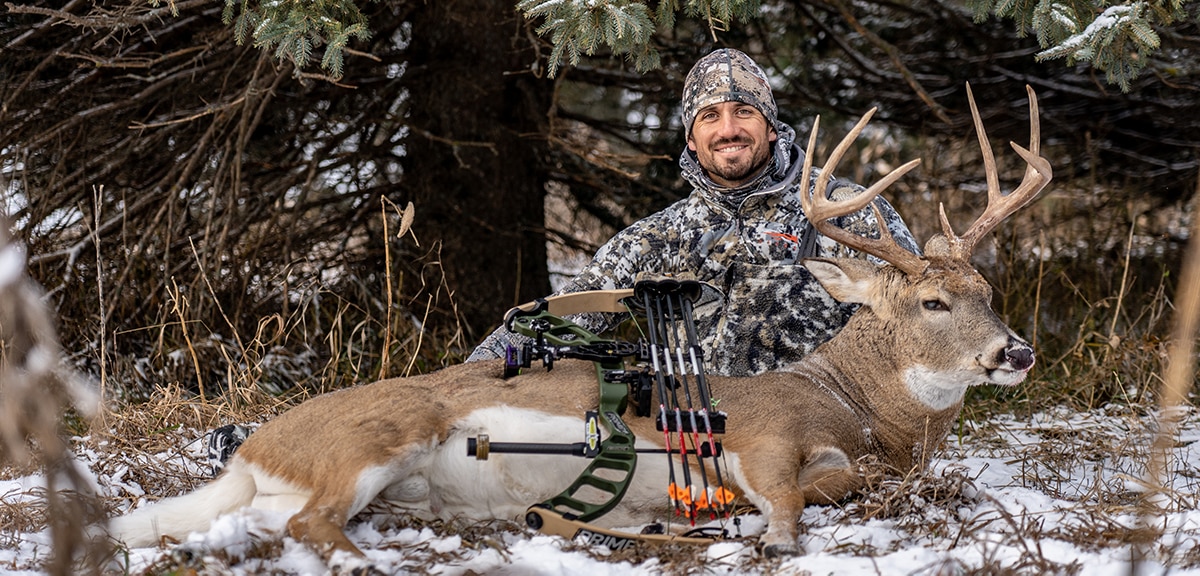 Sam Soholt with an archery deer harvested in the snow.
