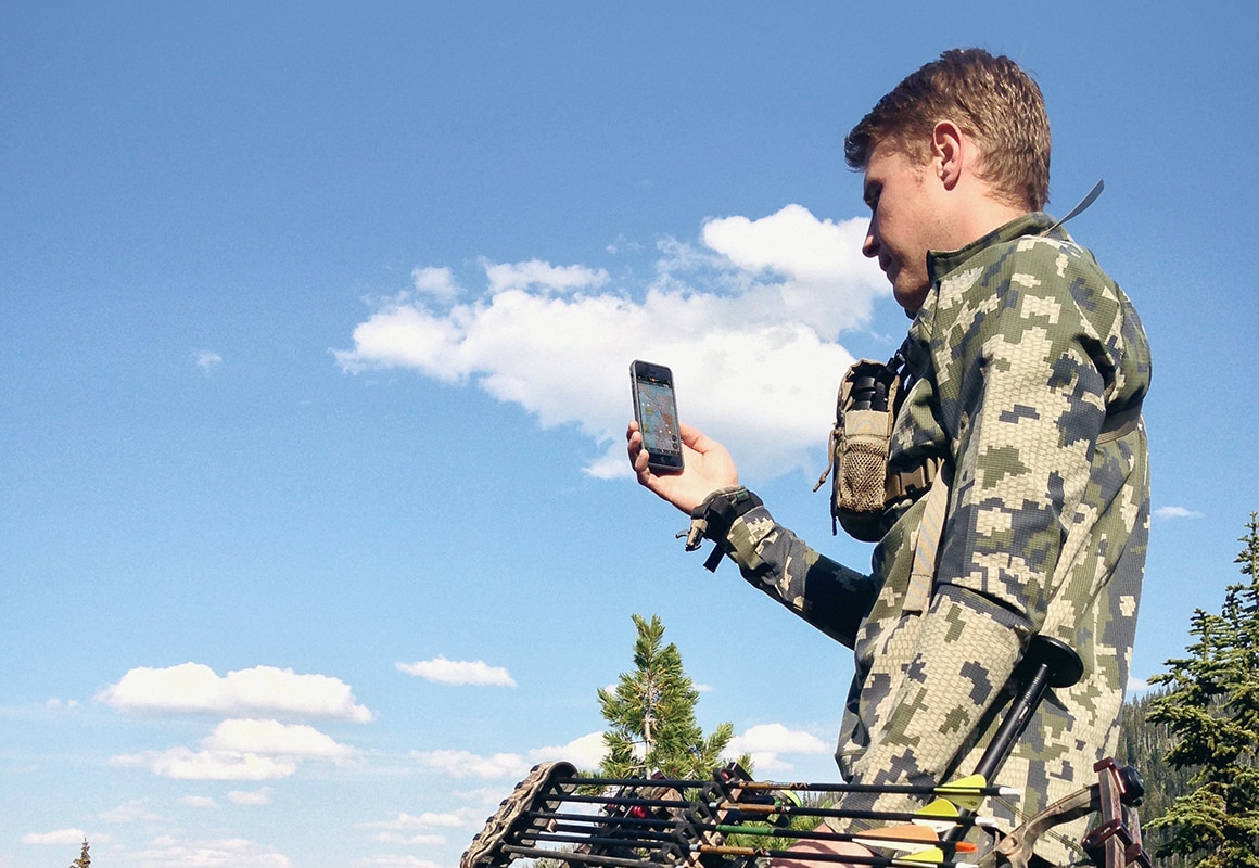 onX Hunt Founder Eric Siegfried bowhunting and using the onX Hunt GPS App on his phone.