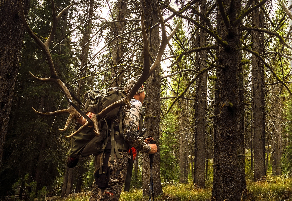 onX Hunt Founder Eric Siegfried packing out an elk while hunting in the mountains.