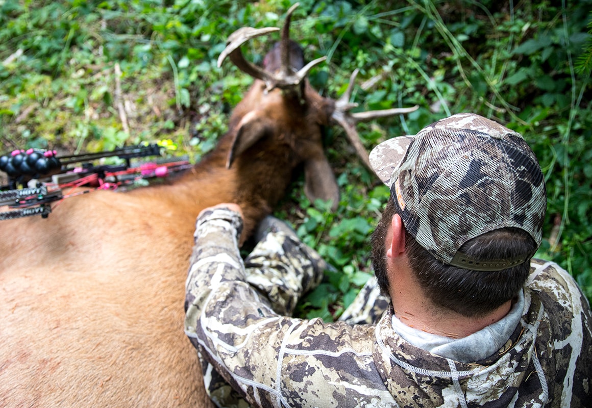 Man with elk shot while bowhunting using onX Hunt Possible Access Layer.