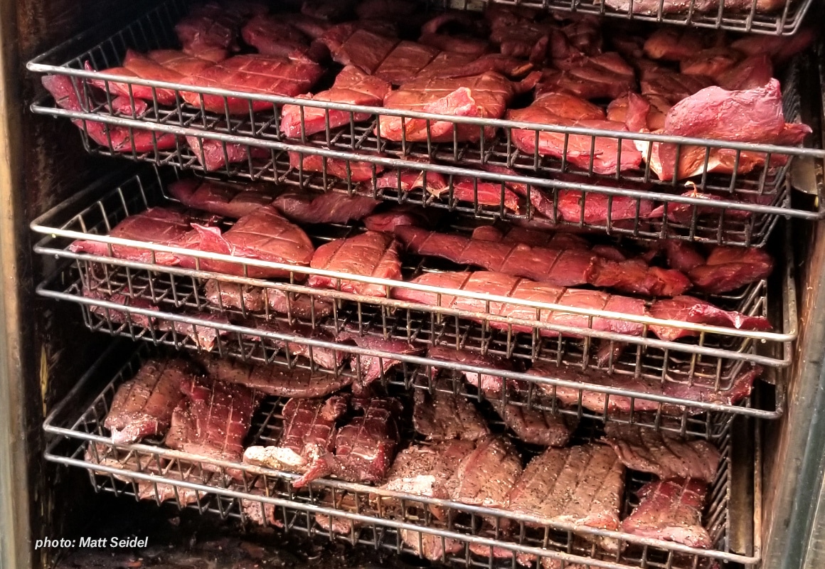 Meat in a large smoker.