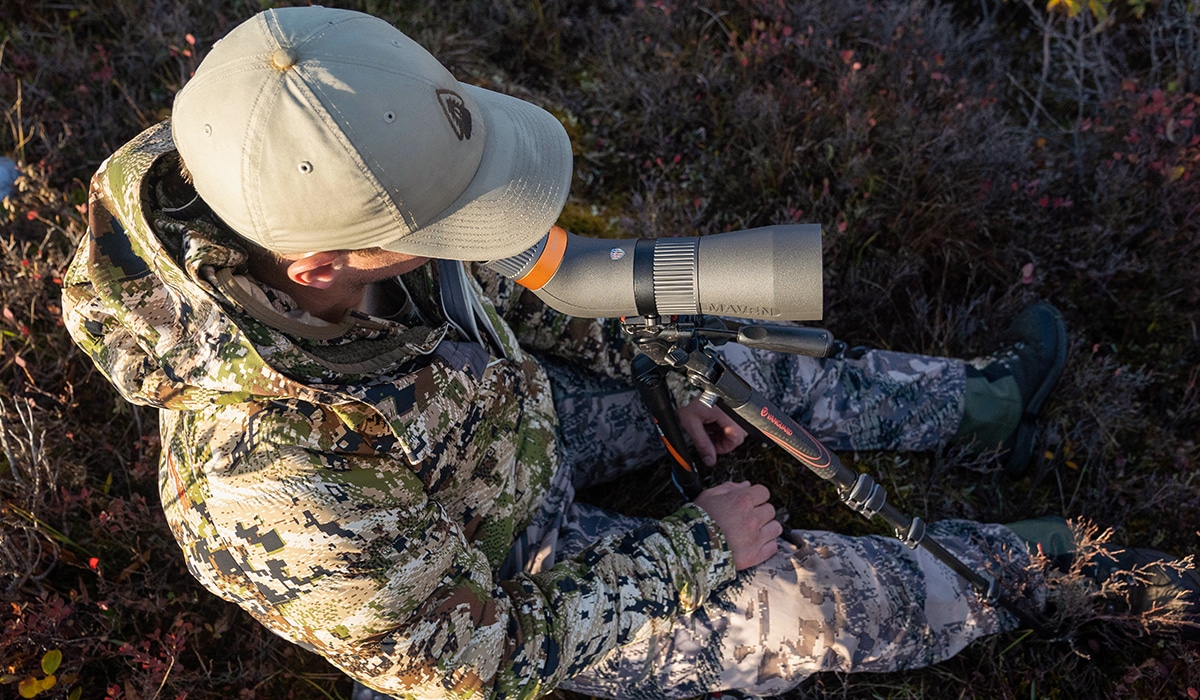 A hunter glassing for caribou while hunting in Alaska.