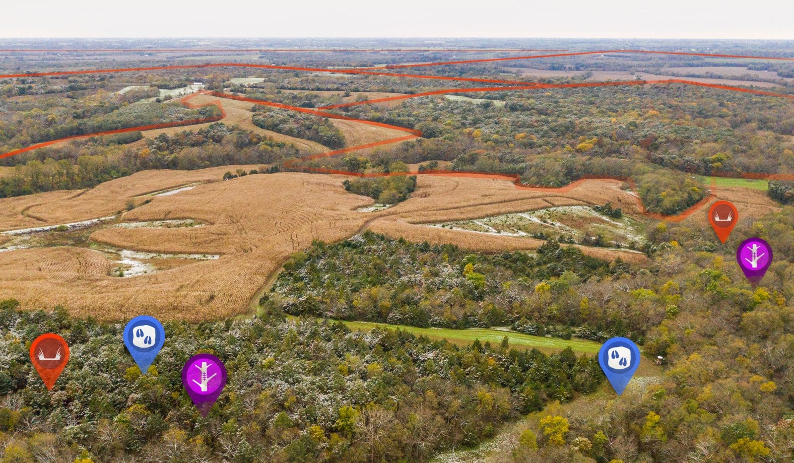 An aerial of fields and trees with onX Hunt Waypoints.