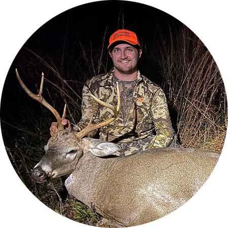 A hunter with the whitetail buck he harvested. 