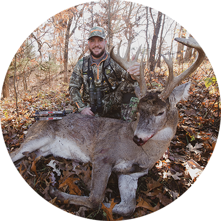 A bowhunter with the whitetail buck he harvested.