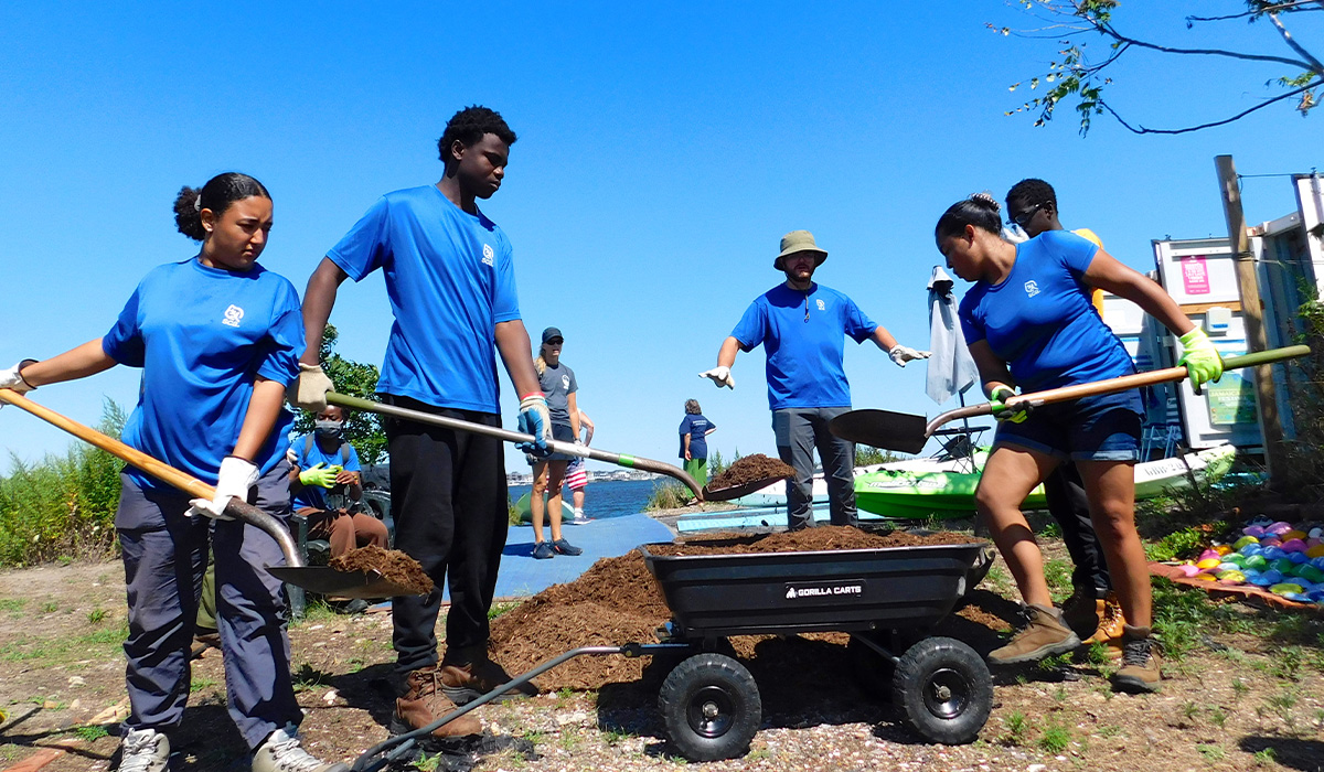 volunteers for the Student Conservation Association digging a garden for a food desert