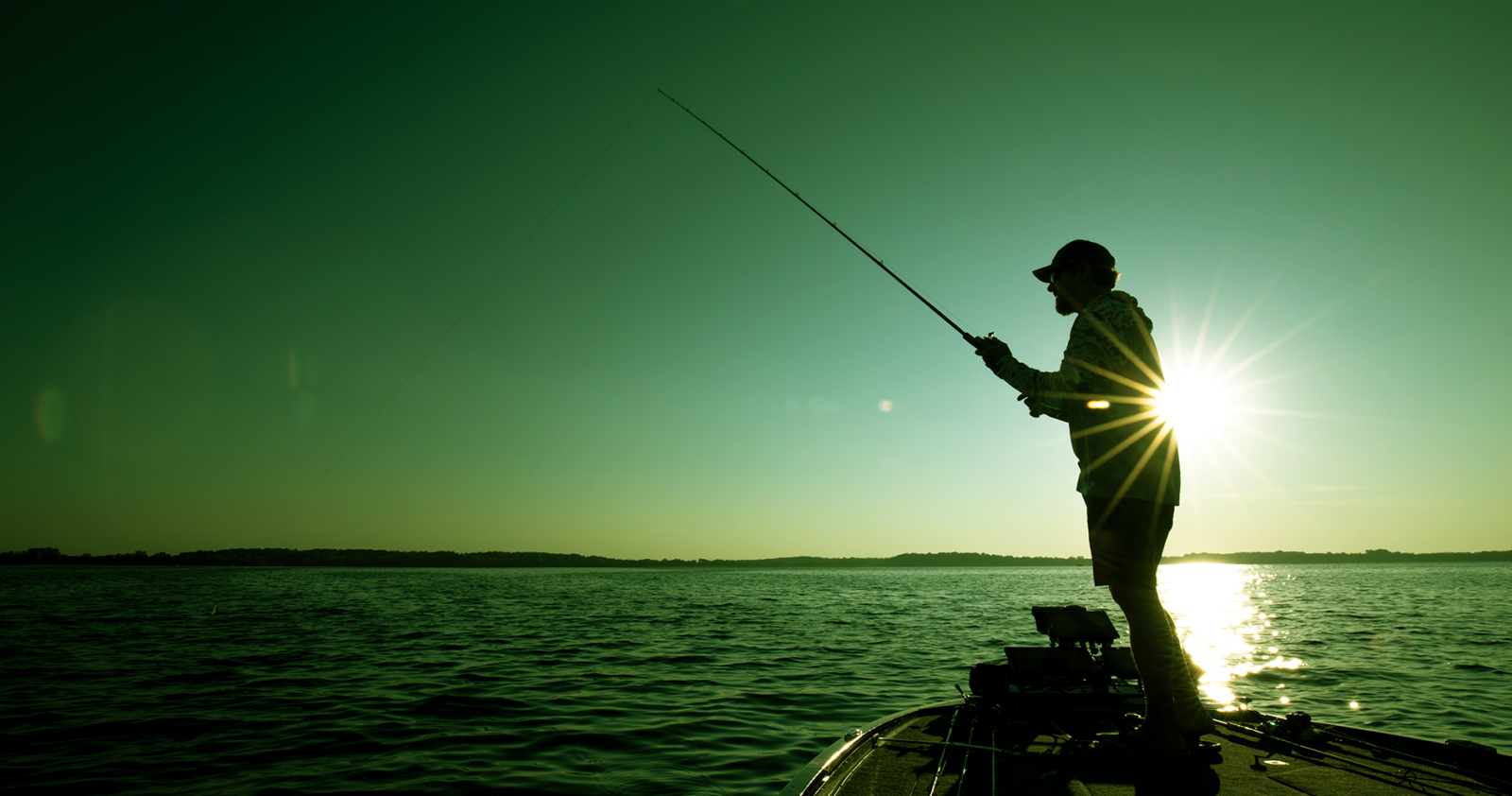 fisherman on a lake at sunrise