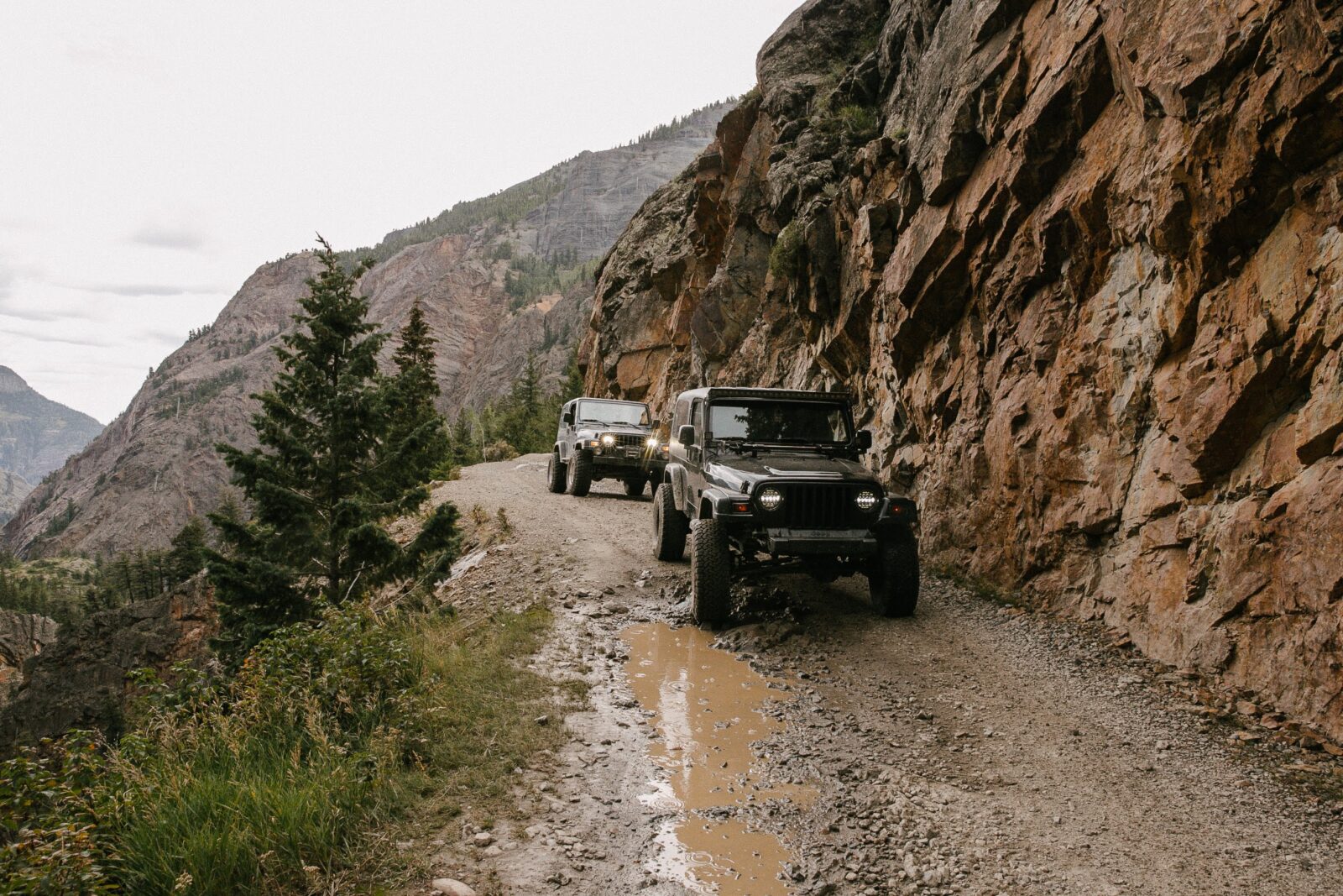 Jeep wranglers on a muddy off-roading trail