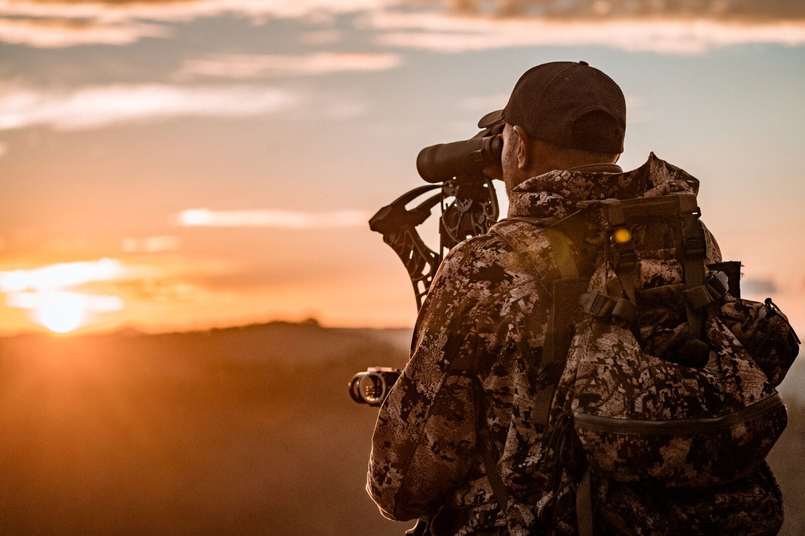 an onX waypoint on a mountain side with a hunter looking towards it