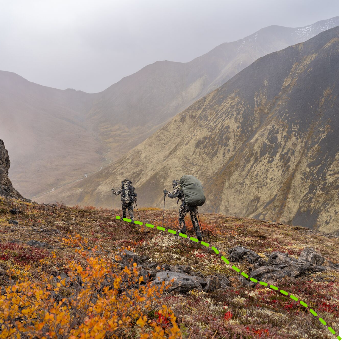 2 hunters hiking a mountain ridge with the onX tracker feature shown