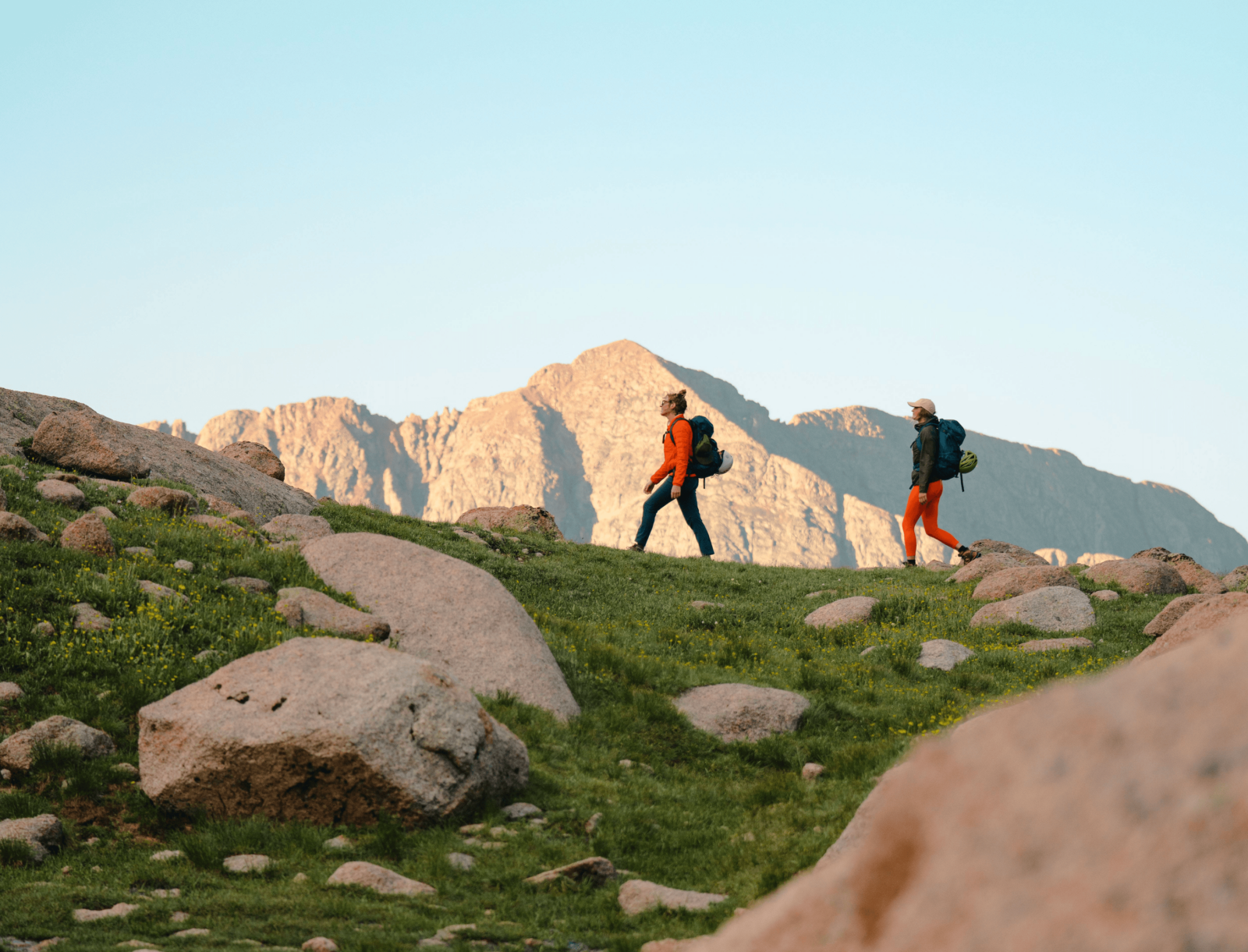 2 hikers on a hillside trail