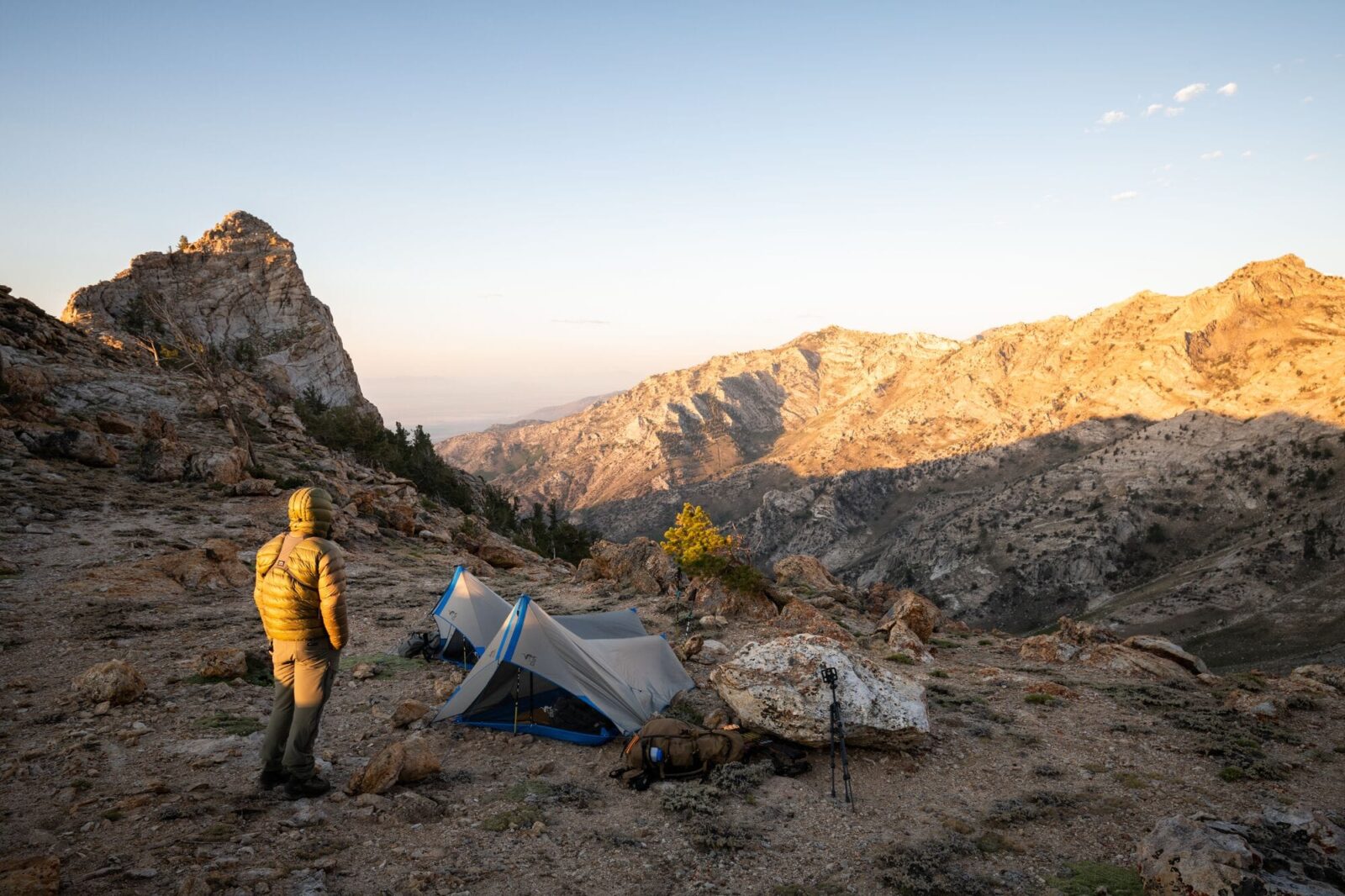 camper with tent on a mountain ridge
