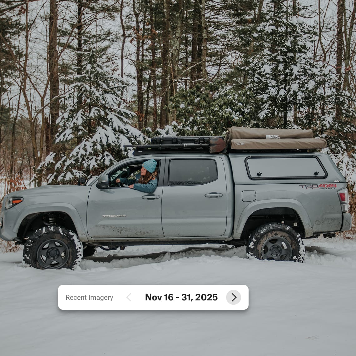 Truck in a snowy forest with onX Recent imagery showing