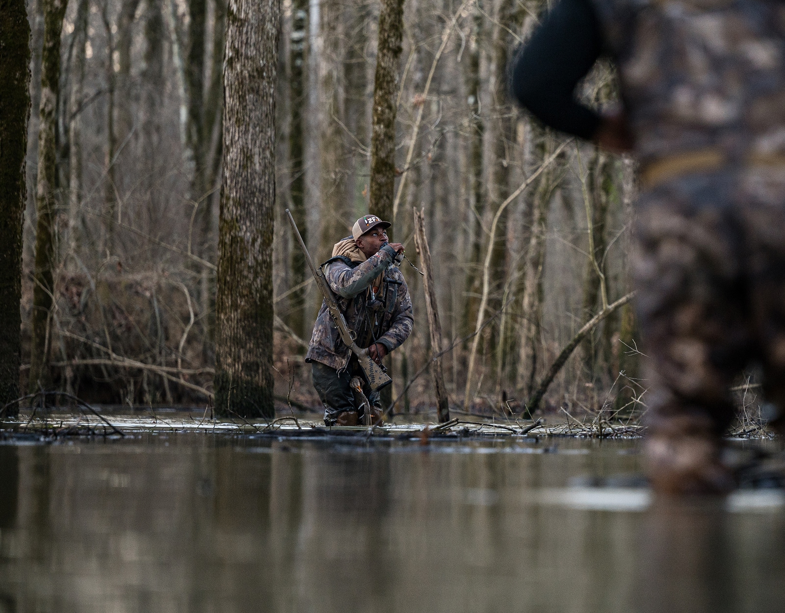A hunter in a marsh.