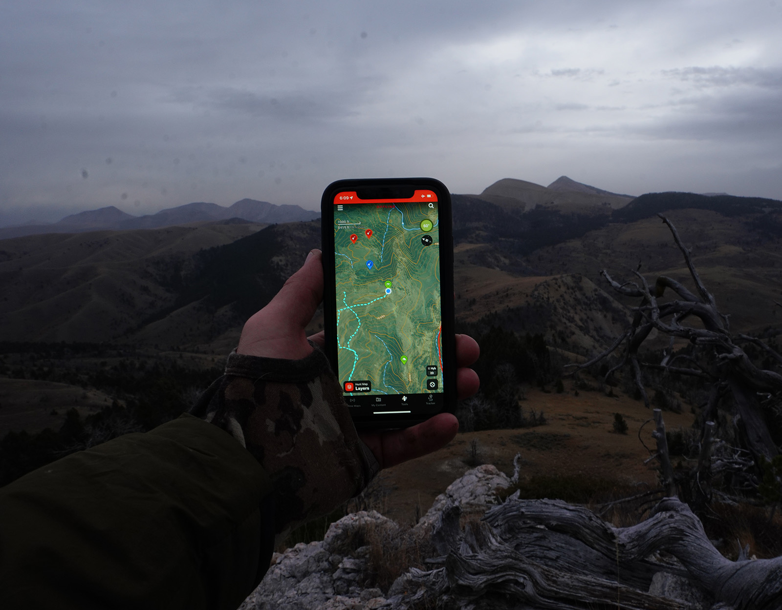 The onX Hunt App shows the Tracker feature and Waypoints. 