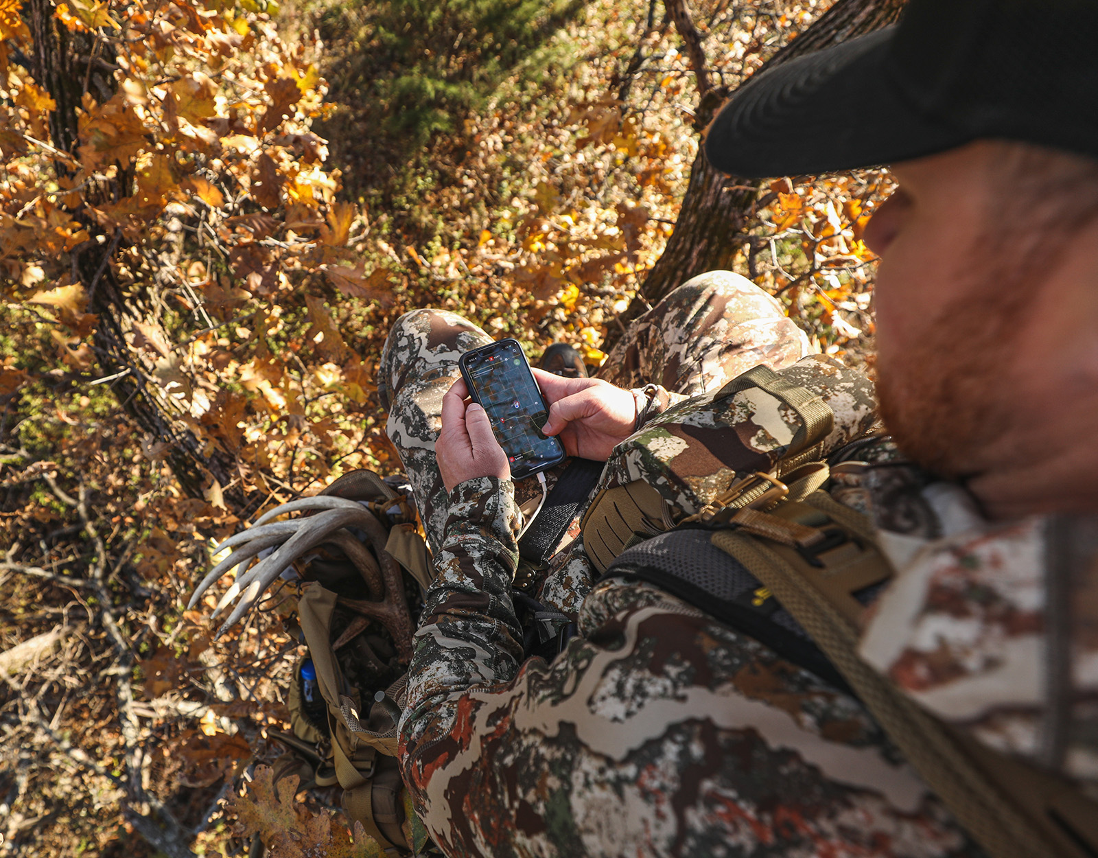 A hunter uses onX Hunt in a treestand. 