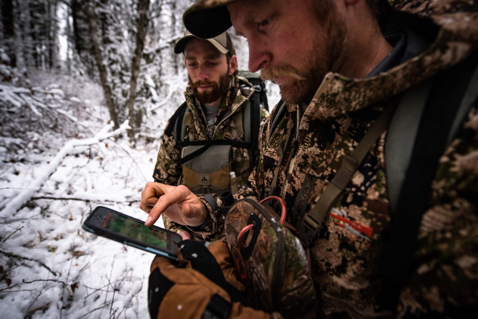 Two hunters use the onX Hunt App in the field. 