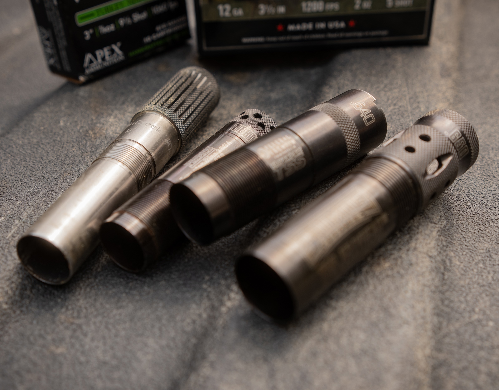 Various turkey shotgun chokes in a pile.