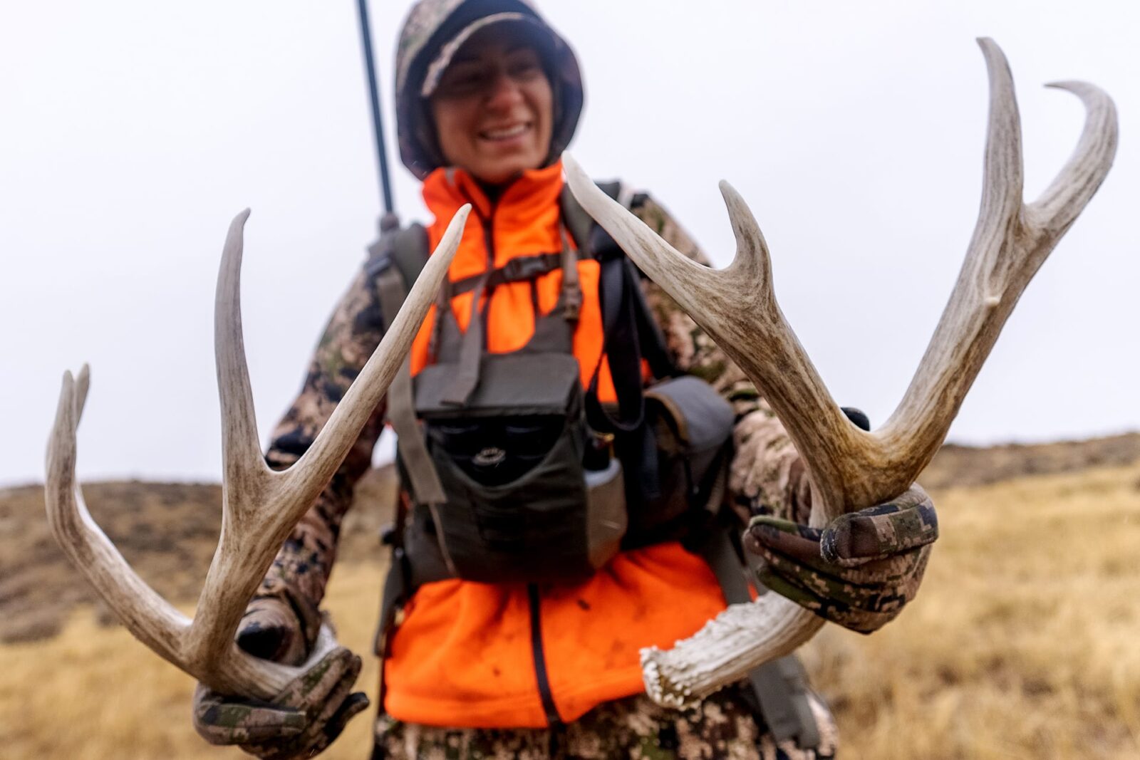 Hunter with mule deer antlers in hand 