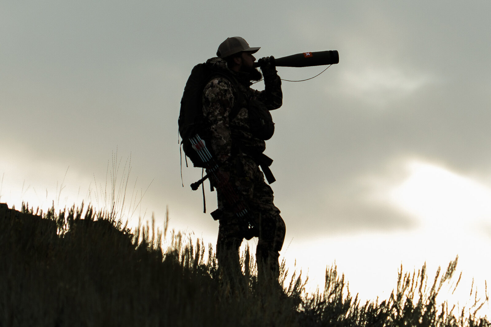 A male hunter uses a bugle tube to call elk. 