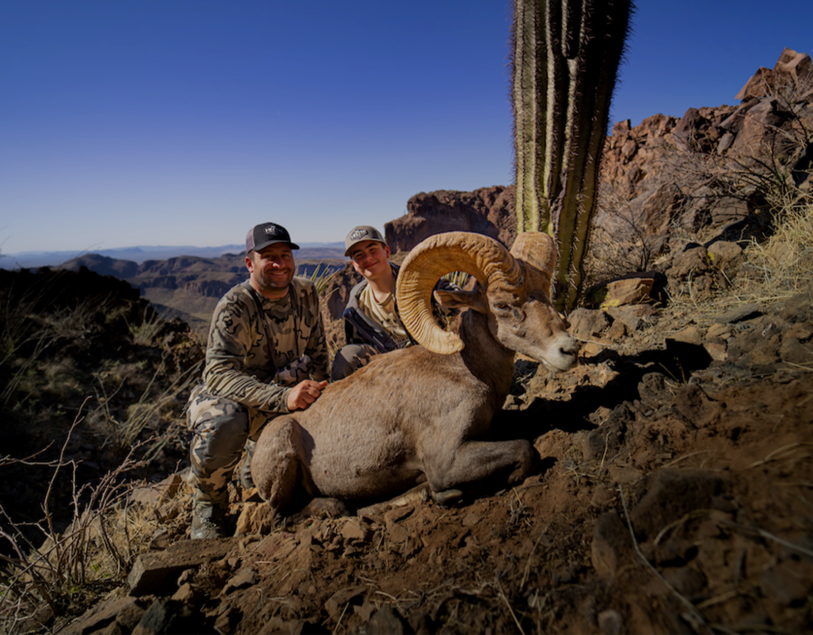 Father and son hunting big horn sheep 