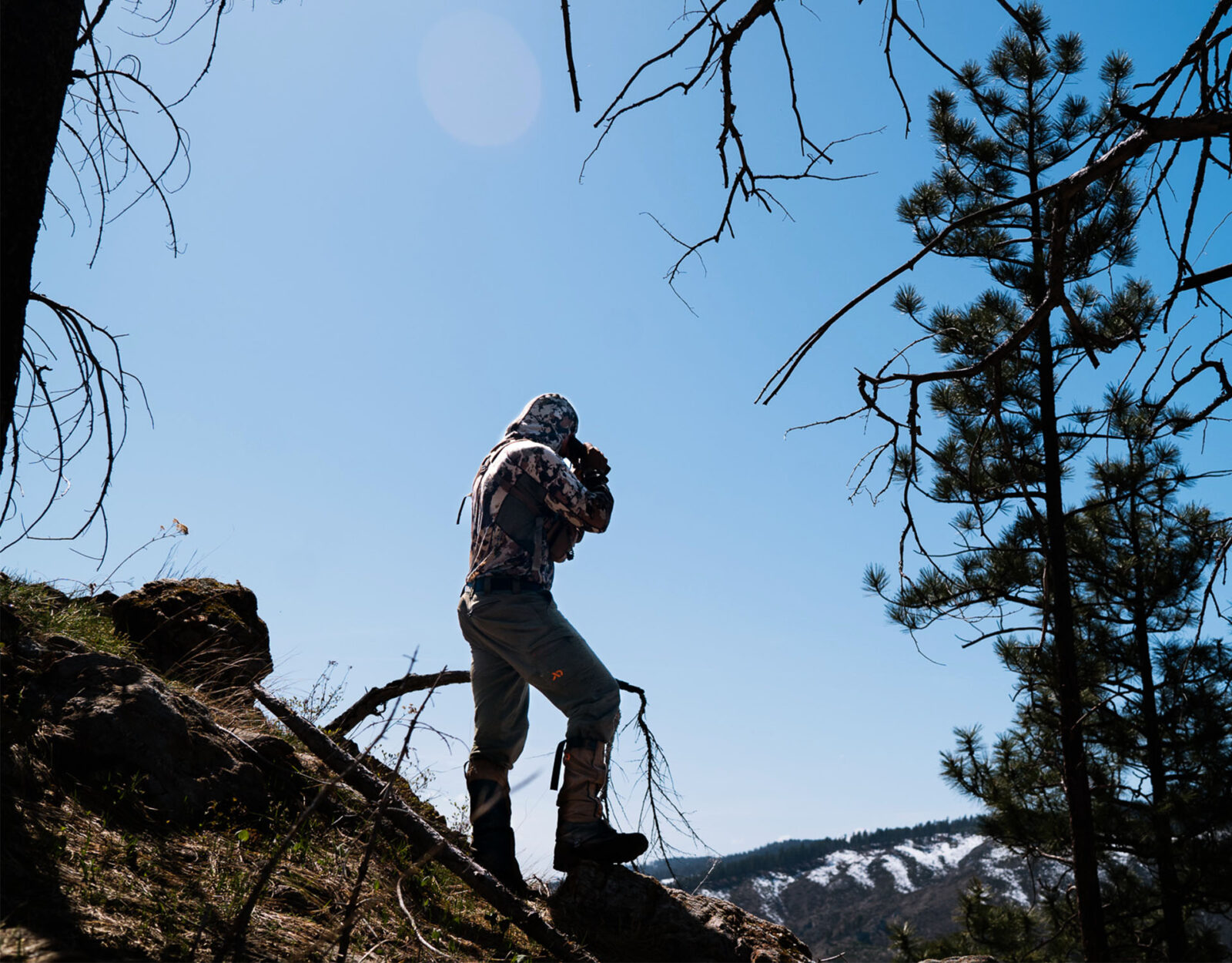 man glassing while hunting the backcountry