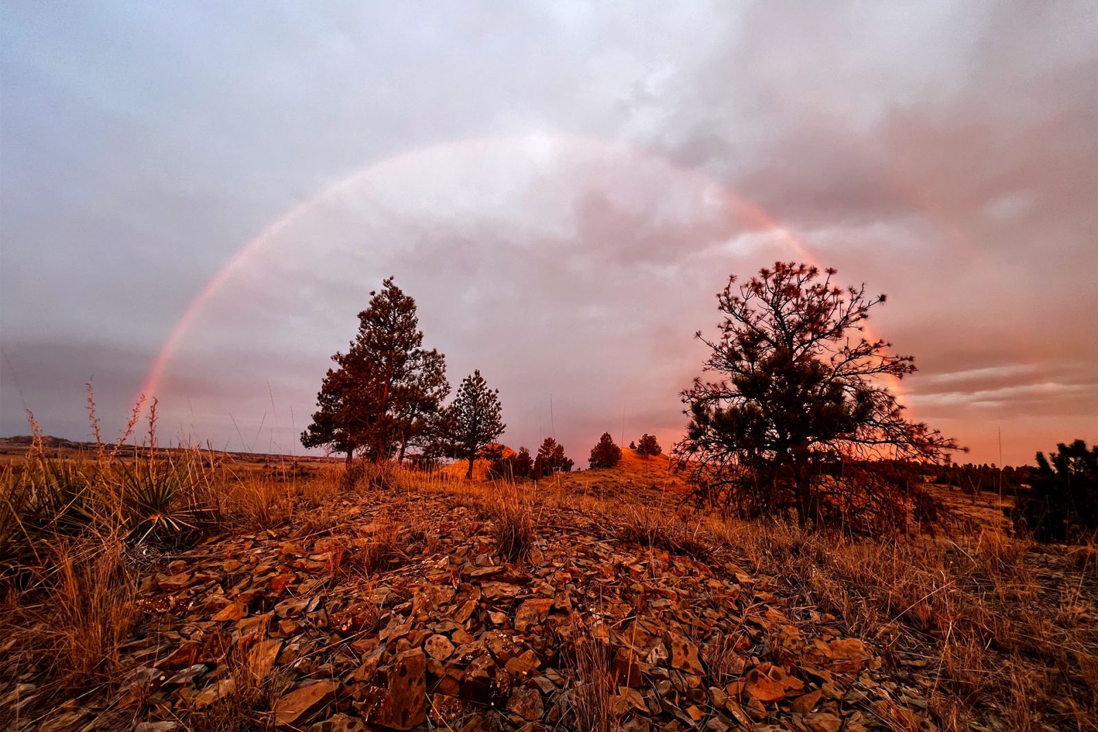 Rainbow over stormy Montana scenery.