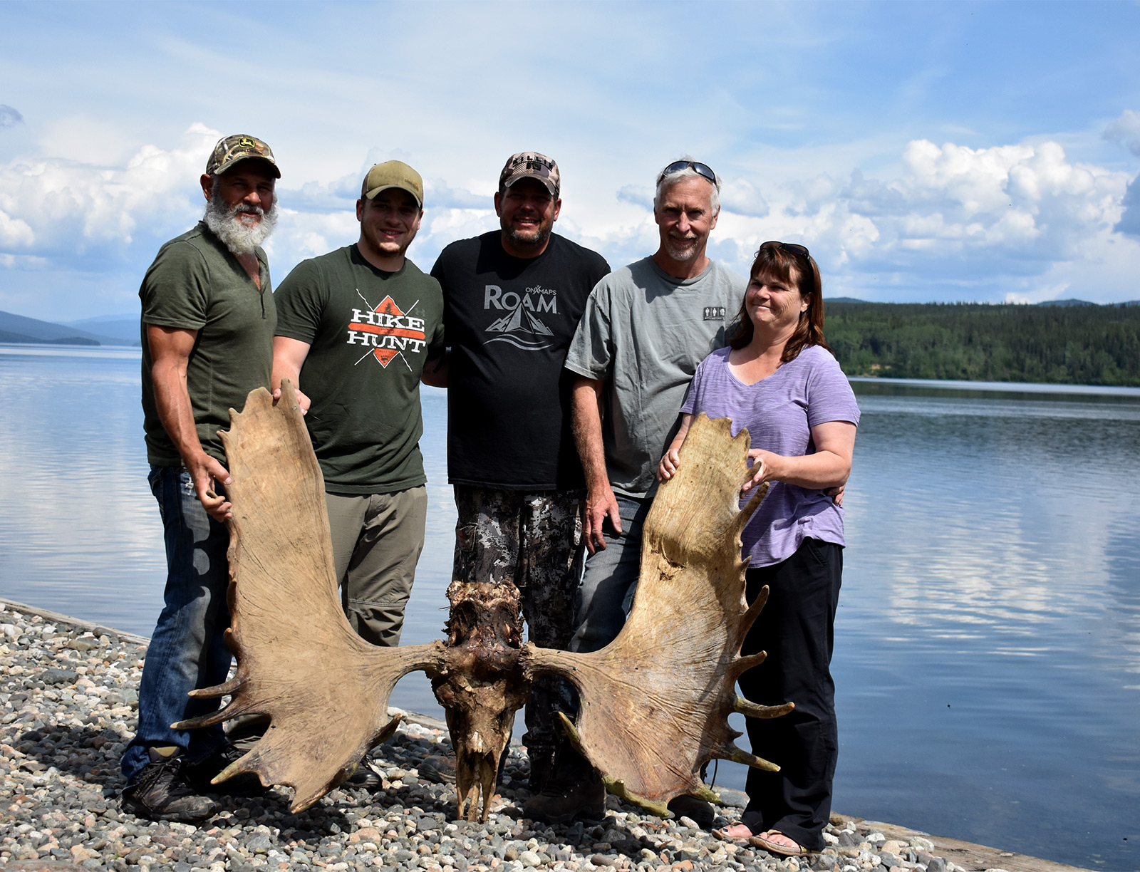 Hunters with a recovered bull moose skull from an Alaska lake.
