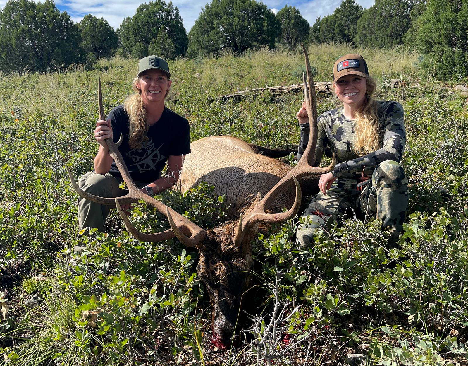 sisters with an elk shot while hutning in Colorado