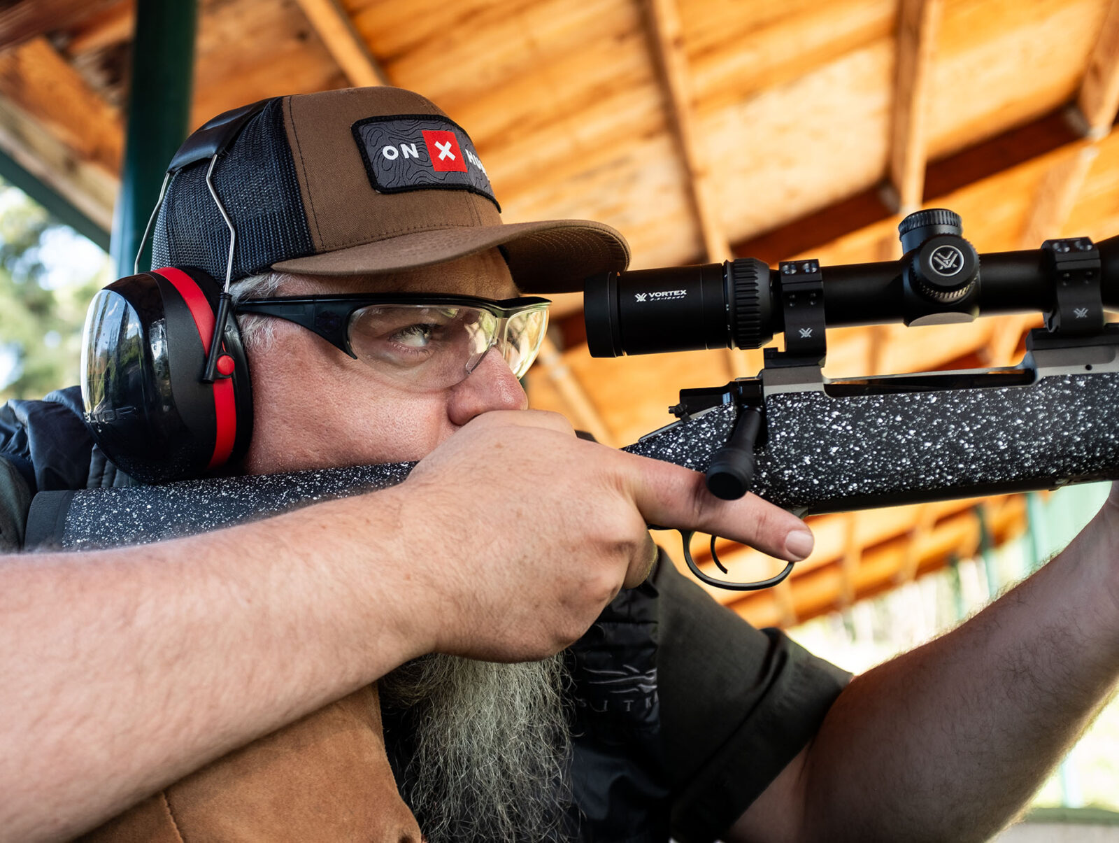 man with a rifle, vortex riflescope and an onX Hunt hat 