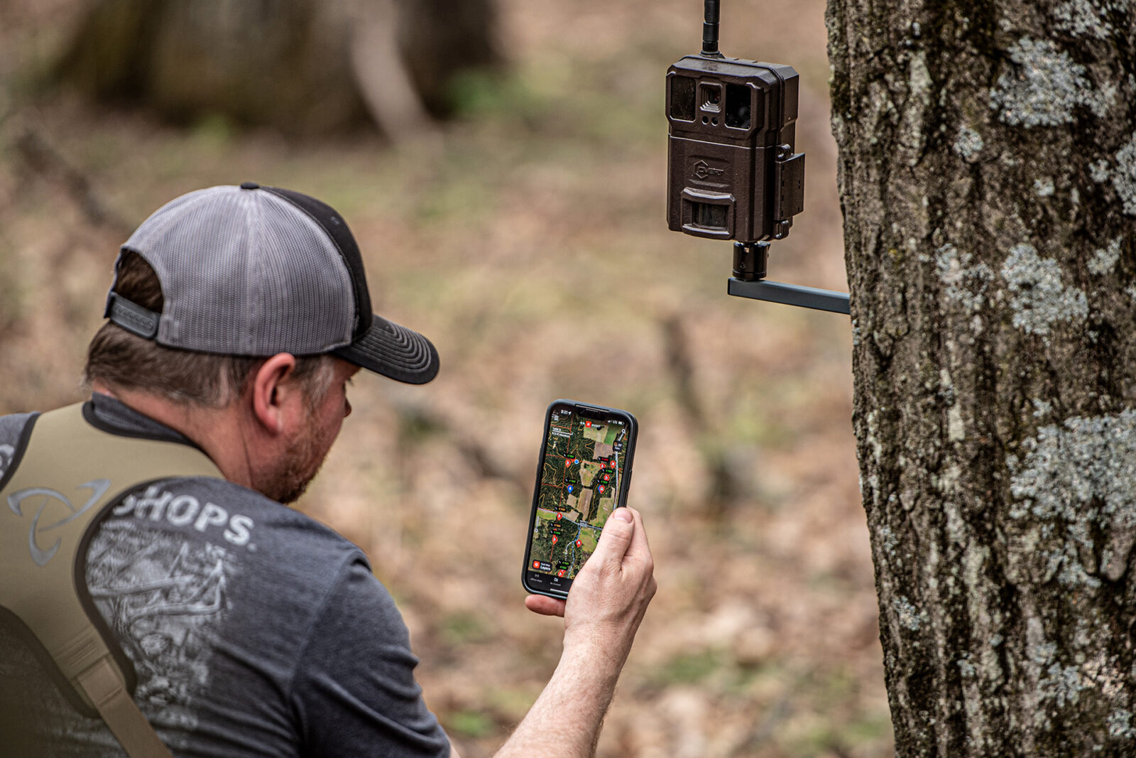 A hunter using onX Hunt's trail camera integration to track deer.