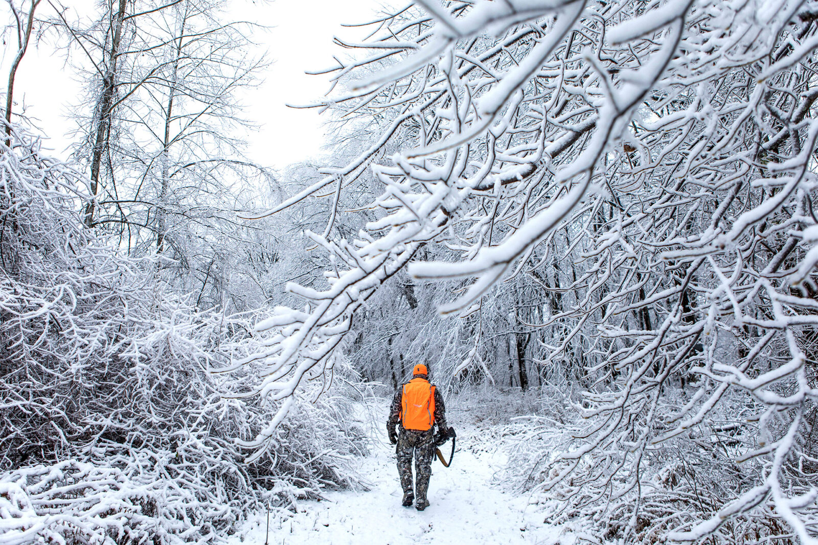 a hunter tracking deer in the snow