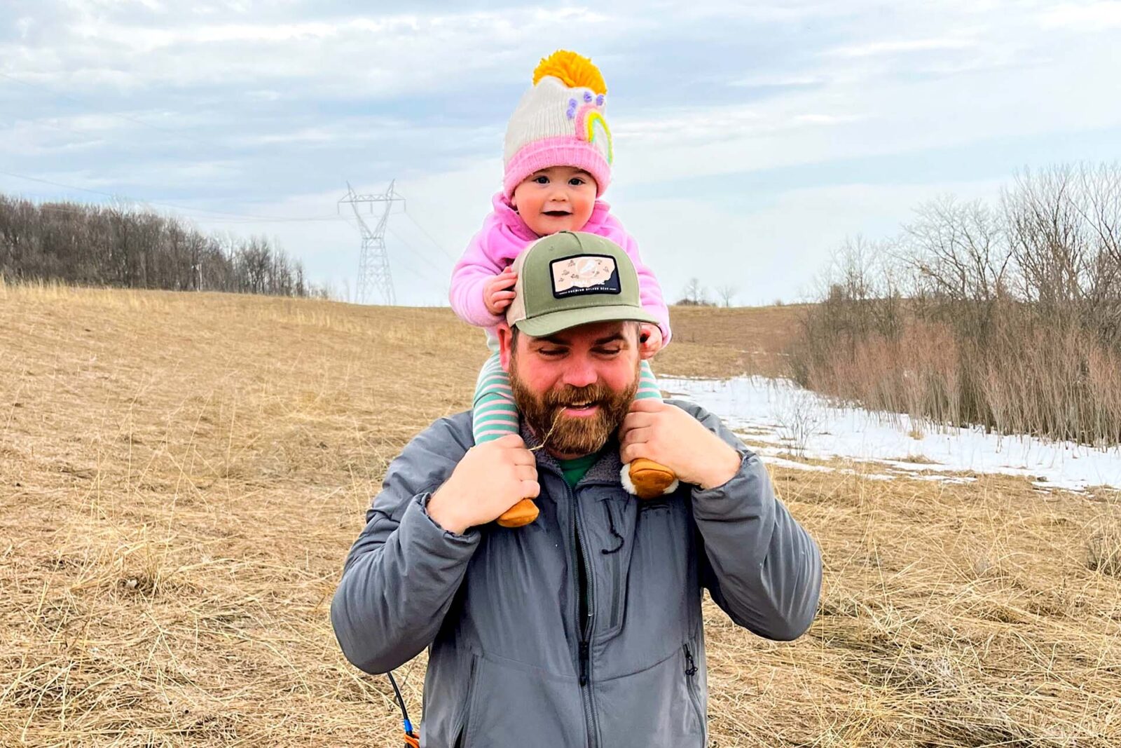 man with daughter on his shoulders 