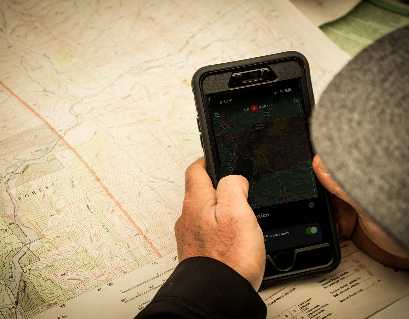 A person uses the onX Hunt App on their mobile device to look at property lines. 