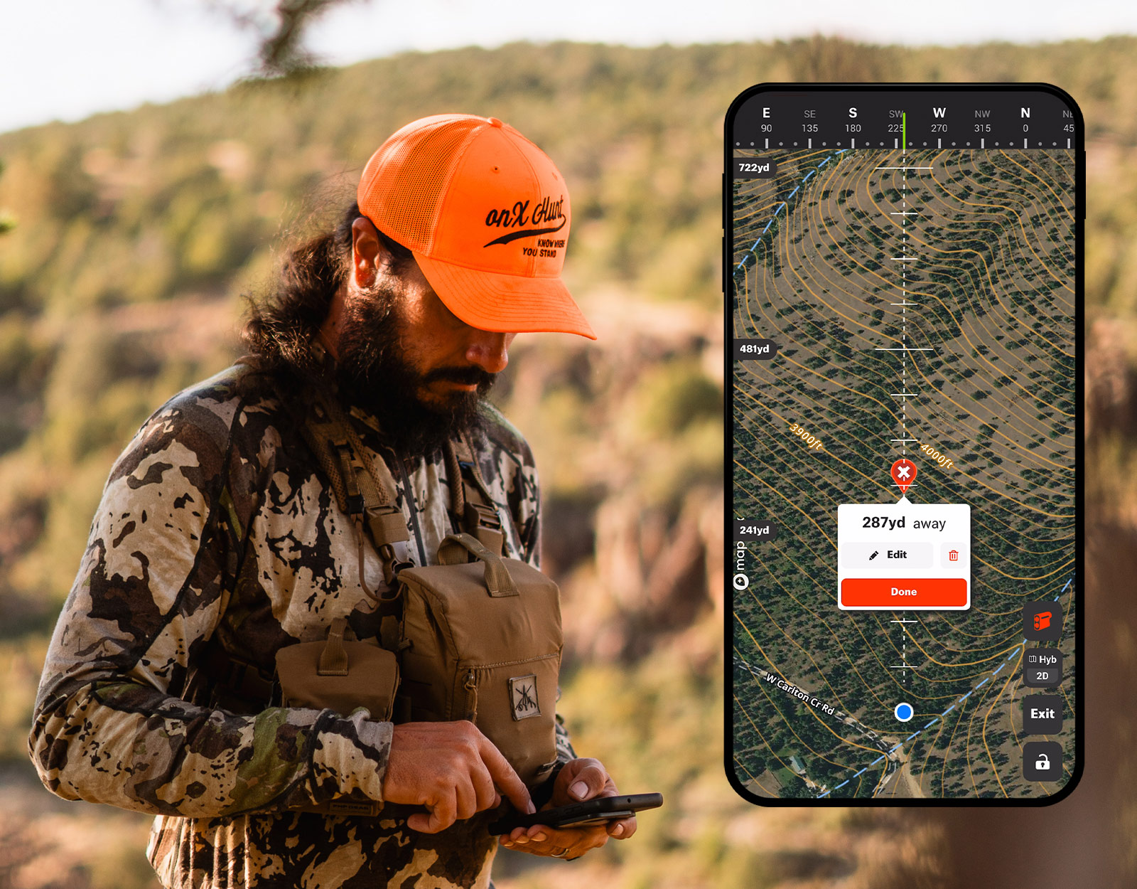 Man marking where an animal was shot while hunting and using the onX Hunt App. 