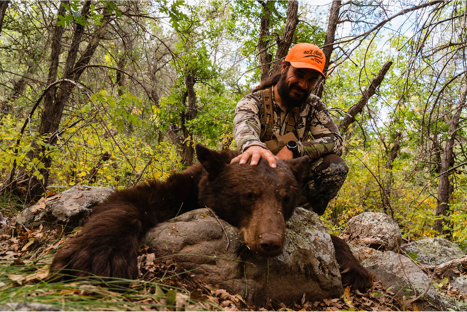 Man with a bear he shot while hunting.