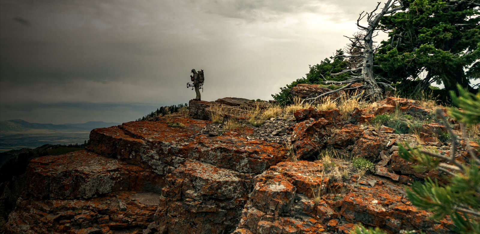 Bow hunter on a ridge e-scouting with onX Hunt Research Tools