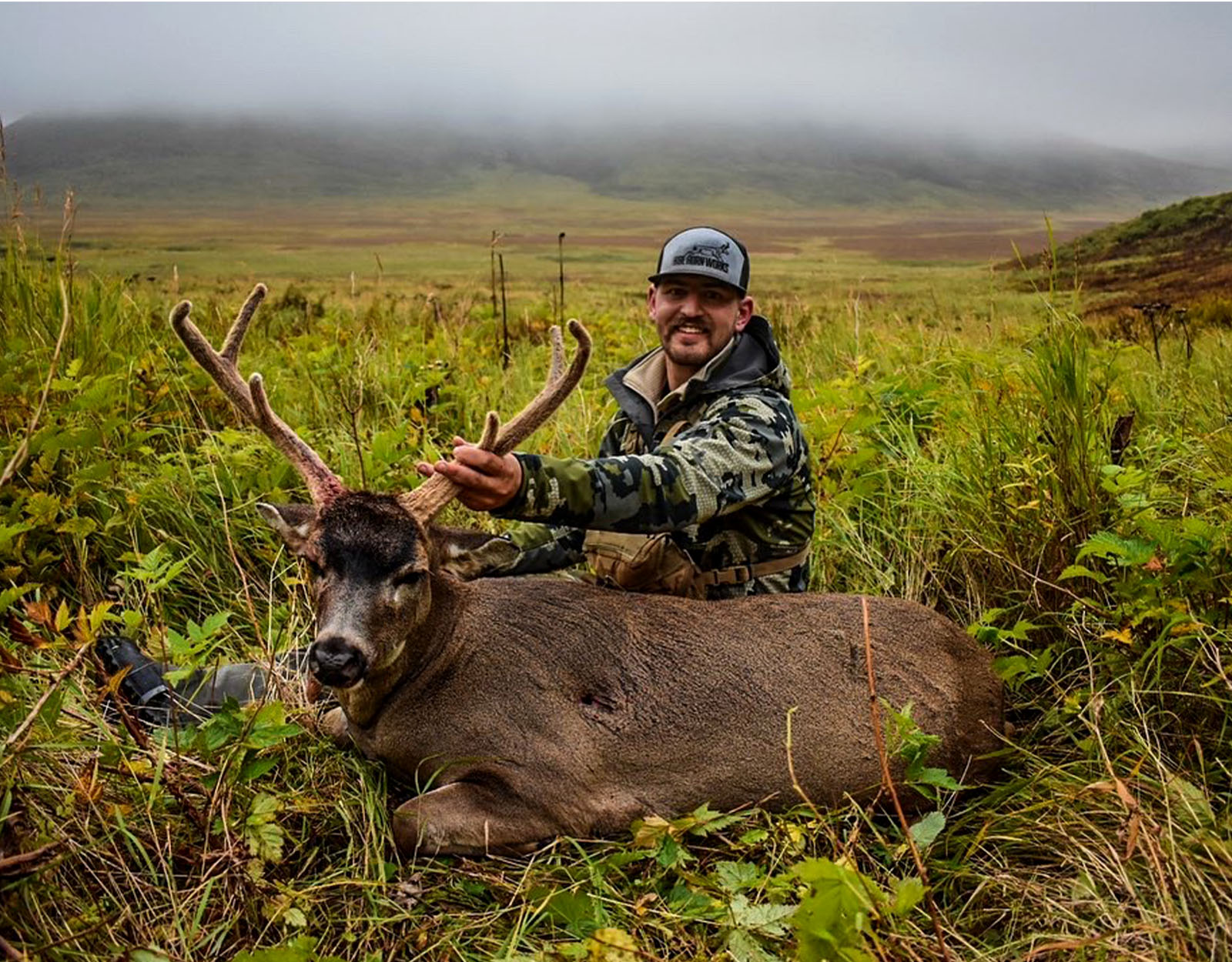 A hunter with the blacktail deer he harvested.