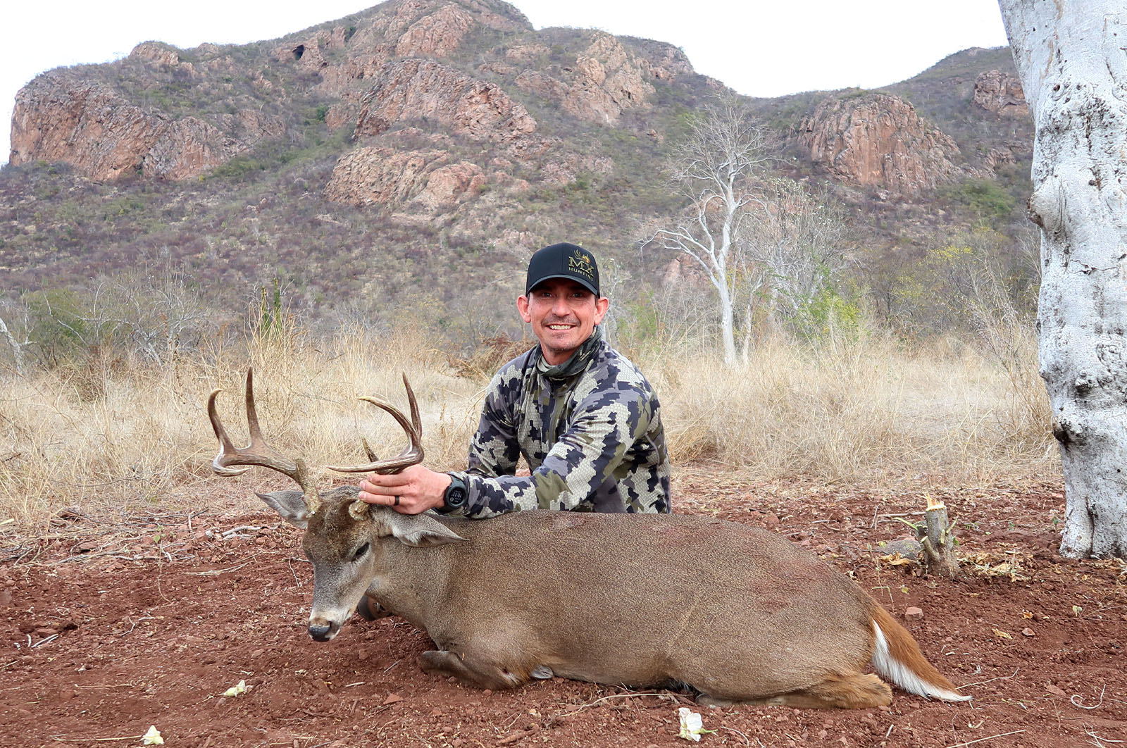 A male hunter with the Coues deer he harvested.