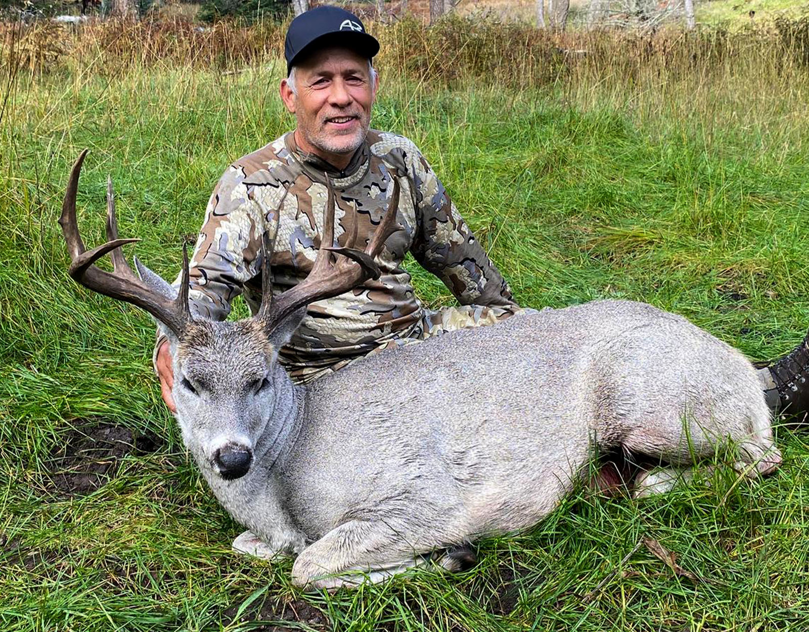 A male hunter with the Coues deer he harvested.