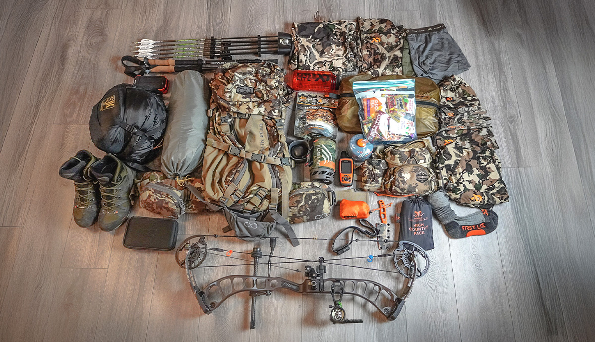 Elk hunting gear laid out on ground.