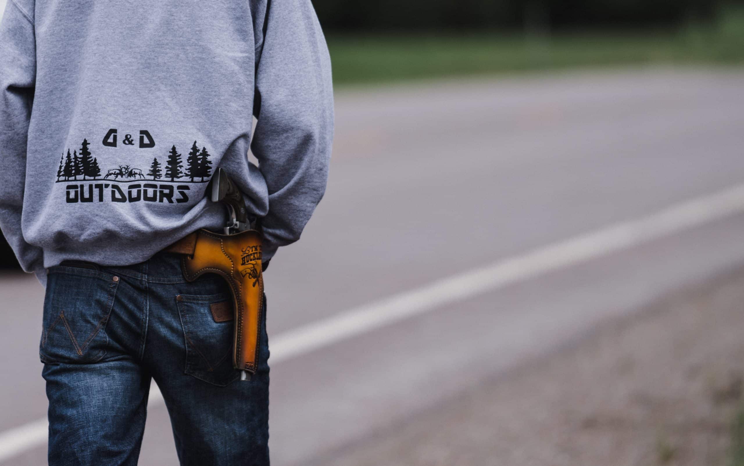 A shed hunter with a pistol in a custom holster on his hip. A shed hunter with a pistol in a custom holster on his hip.