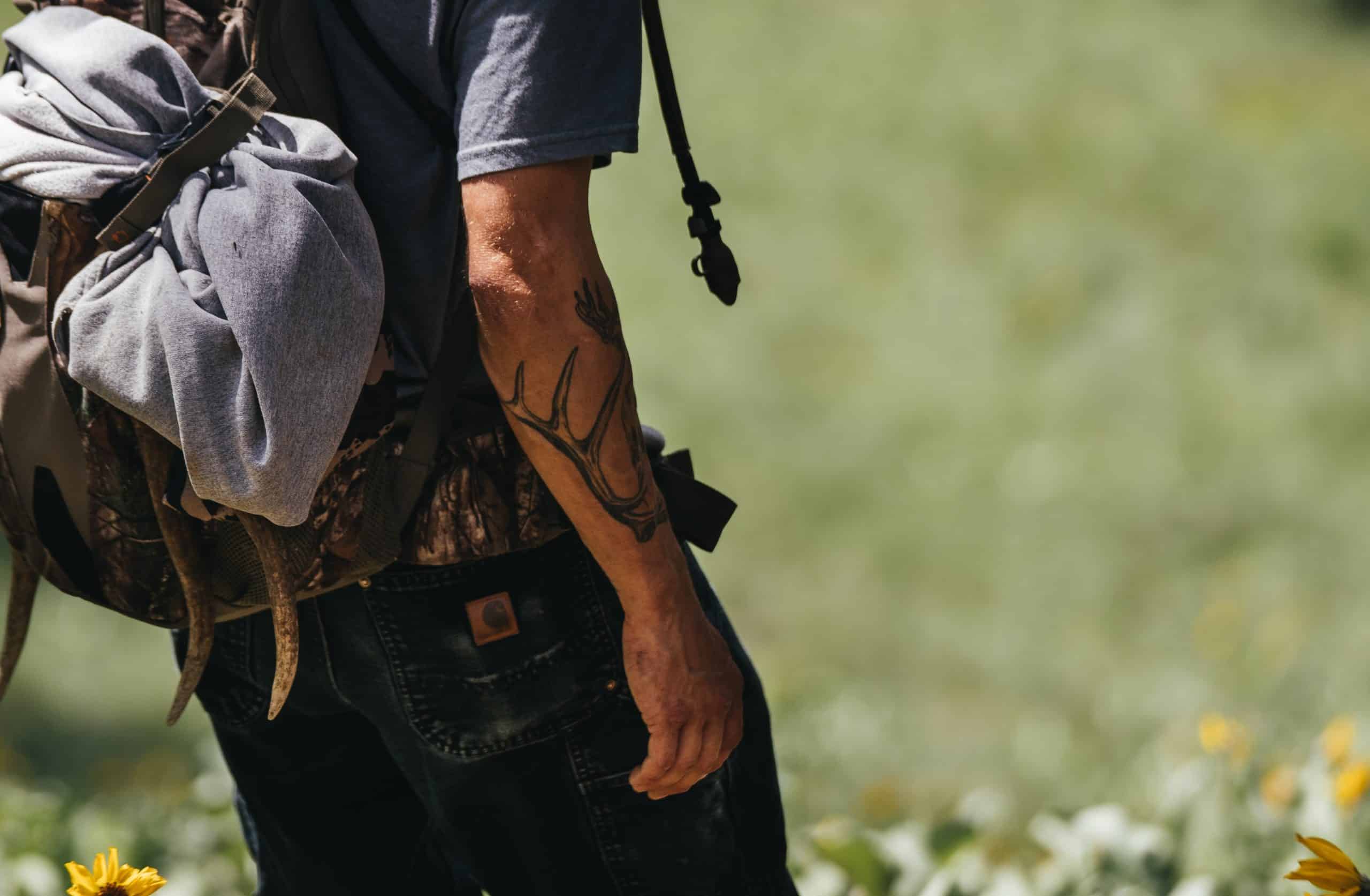 Shed tines stick out of the pack and match an antler tattoo. Shed tines stick out of the pack and match an antler tattoo.