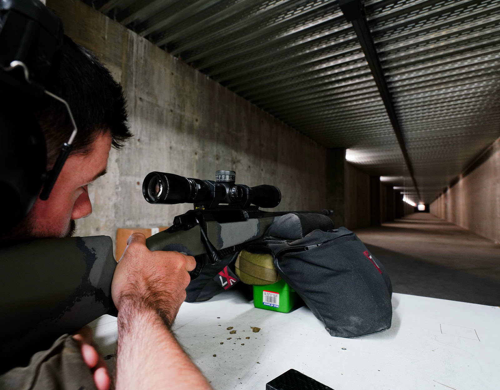 A man takes aim at a shooting range.