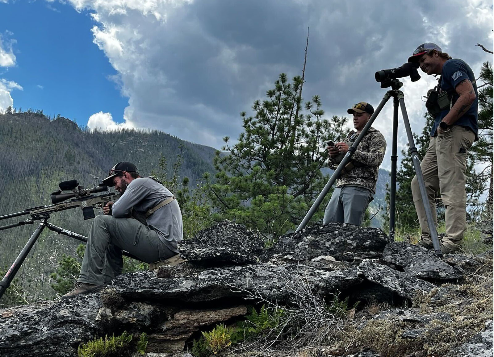 A spotter and a shooter set up for a shot at a long-range shooting range.